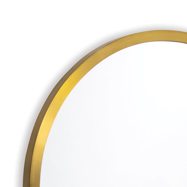 Top left edge of a round brass mirror